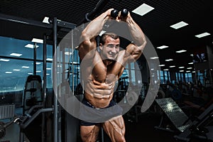 Strong Athletic Man bodybuilder Torso showing muscles in gym