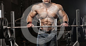Strong Athletic Man bodybuilderl Torso showing muscles in gym