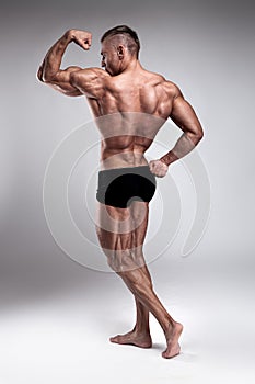 Strong Athletic Man Fitness Model posing back muscles