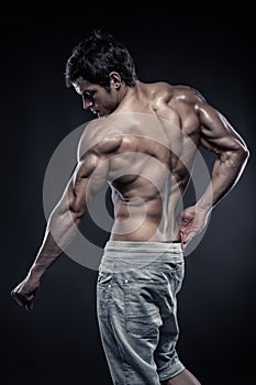 Strong Athletic Man Fitness Model posing back muscles