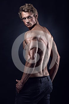 Strong Athletic Man Fitness Model posing back muscles