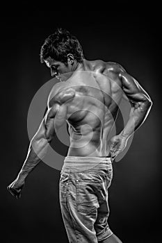 Strong Athletic Man Fitness Model posing back muscles, triceps,