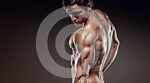Strong Athletic Man Fitness Model posing back muscles and triceps, copyspace