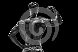 Strong Athletic Man Fitness Model posing back muscles, triceps o