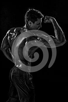 Strong Athletic Man Fitness Model posing back muscles, triceps o