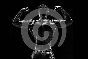 Strong Athletic Man Fitness Model posing back muscles, triceps o