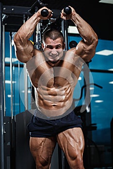 Strong Athletic Man Fitness Model Torso showing muscles in gym