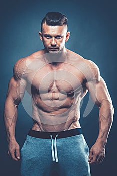 Strong Athletic Man Fitness Model Torso showing six pack abs. is