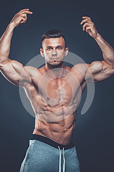 Strong Athletic Man Fitness Model Torso showing six pack abs. is