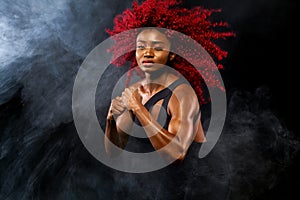 A strong athletic woman on black background wearing in sportswear, fitness and sport motivation. Sport concept with copy