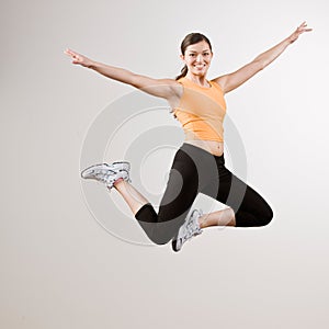 Strong athletic woman jumping in mid-air