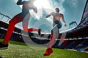 Strong athletic woman sprinter, running on stadium wearing in sportswear. Fitness and sport motivation. Runner concept.