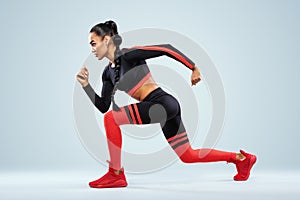 A strong athletic, women sprinter, running wearing in the sportswear, fitness and sport motivation. Runner concept with