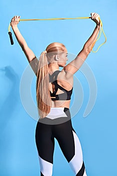 Strong awesome sportswoman stretching skipping rope