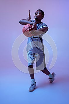 Strong basketball player hand holds ball