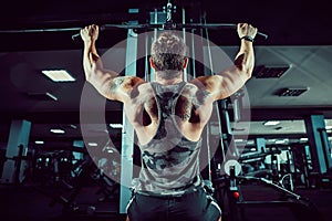 Strong Bodybuilder Doing Heavy Weight Exercise For Back On Machine