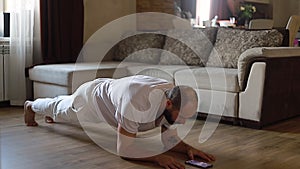 Strong bearded guy doing plank exercise