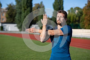 Strong bearded man warms up before training