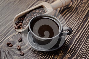 Strong black coffee beans,coffee, black roasted arabica coffee beans and cup full of coffee