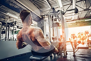 Strong Bodybuilder Doing Heavy Weight Exercise For Back On Machine