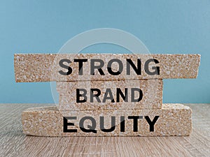 Strong brand equity symbol. Concept words Strong brand equity on brick blocks