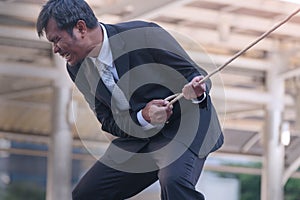 Strong businessman pulling a rope. Asian Business in tug of war