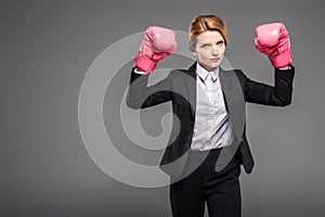 strong businesswoman in pink boxing gloves