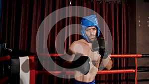 Strong Caucasian sport boxer warming up to prepare for boxing in the boxing ring. intimidate an opponent Build up your self-