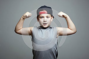 Strong Child. Funny Little Boy in Hat. Sport Handsome Kid