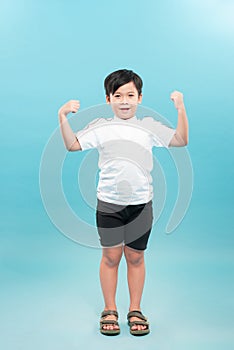 Strong Child. Funny Little Boy.Sport Handsome Boy.bodybuilder showing his hand biceps muscles