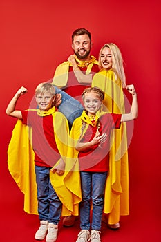 Strong children and parents superheroes isolated in studio