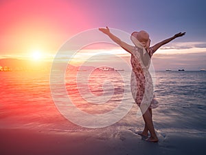 Strong confidence woman open arms under the sunrise at seaside