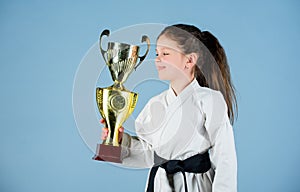 Strong and confident kid. Girl little child in white kimono with belt. Karate fighter child. Karate sport concept. Self