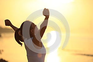 strong confident woman open arms on beach