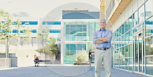 Strong, determined older man outside a modern company
