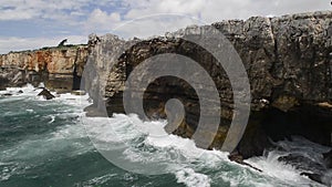 Strong extreme waves crash into grotto cliff cave, Boca do Inferno, Portugal
