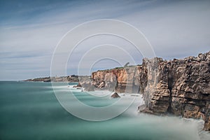 Strong extreme waves crash into grotto cliff cave, Boca do Inferno, Portugal