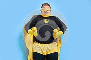 Strong fat superhero shows muscles