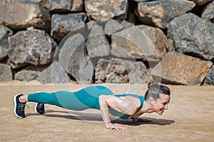 Strong female doing Low Push up pose