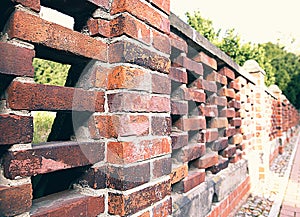 A strong fence made of red brick with turrets, architectural structure