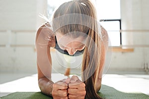 Strong fit woman doing fitness exercises on the muscles of the press