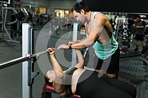 Strong fitness coach training a young woman