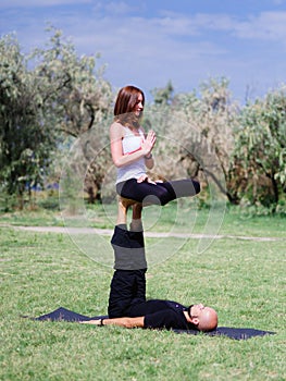 Morning yoga in the city green park. A beautiful couple holds a yoga class