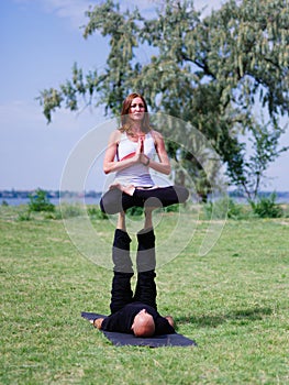 Morning yoga in the city green park. A beautiful couple holds a yoga class