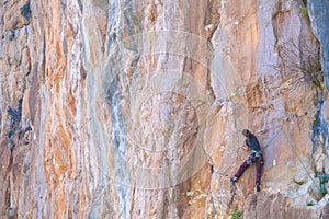 A strong girl climbs a rock, Rock climbing in Turkey