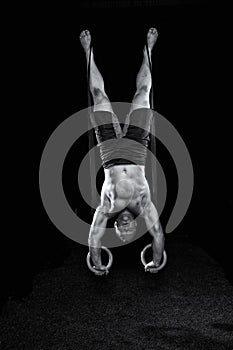 Strong gymnast works on the rings