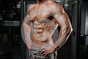 Strong and handsome athletic young man muscles abs and biceps