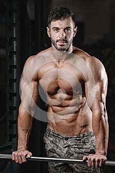 Strong and handsome athletic young man muscles abs and biceps