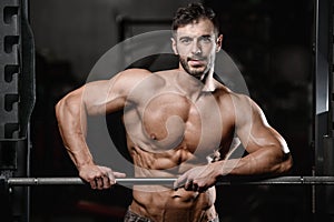 Strong and handsome athletic young man muscles abs and biceps