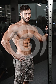 Strong and handsome athletic young man muscles abs and biceps